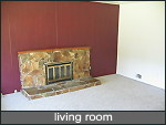 living room with wood burning fireplace